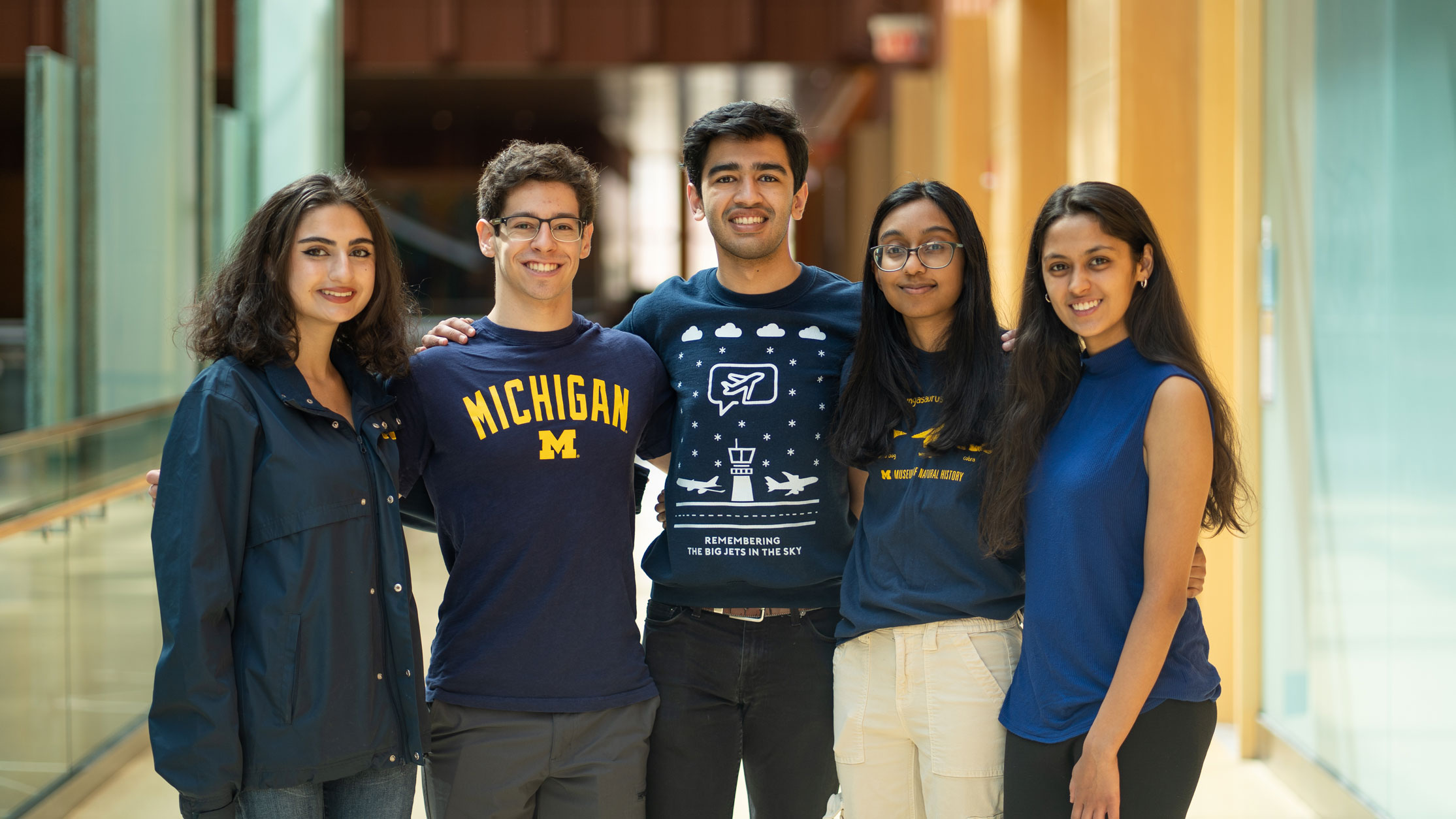 Computational modeling team, made up of five members, smiling.